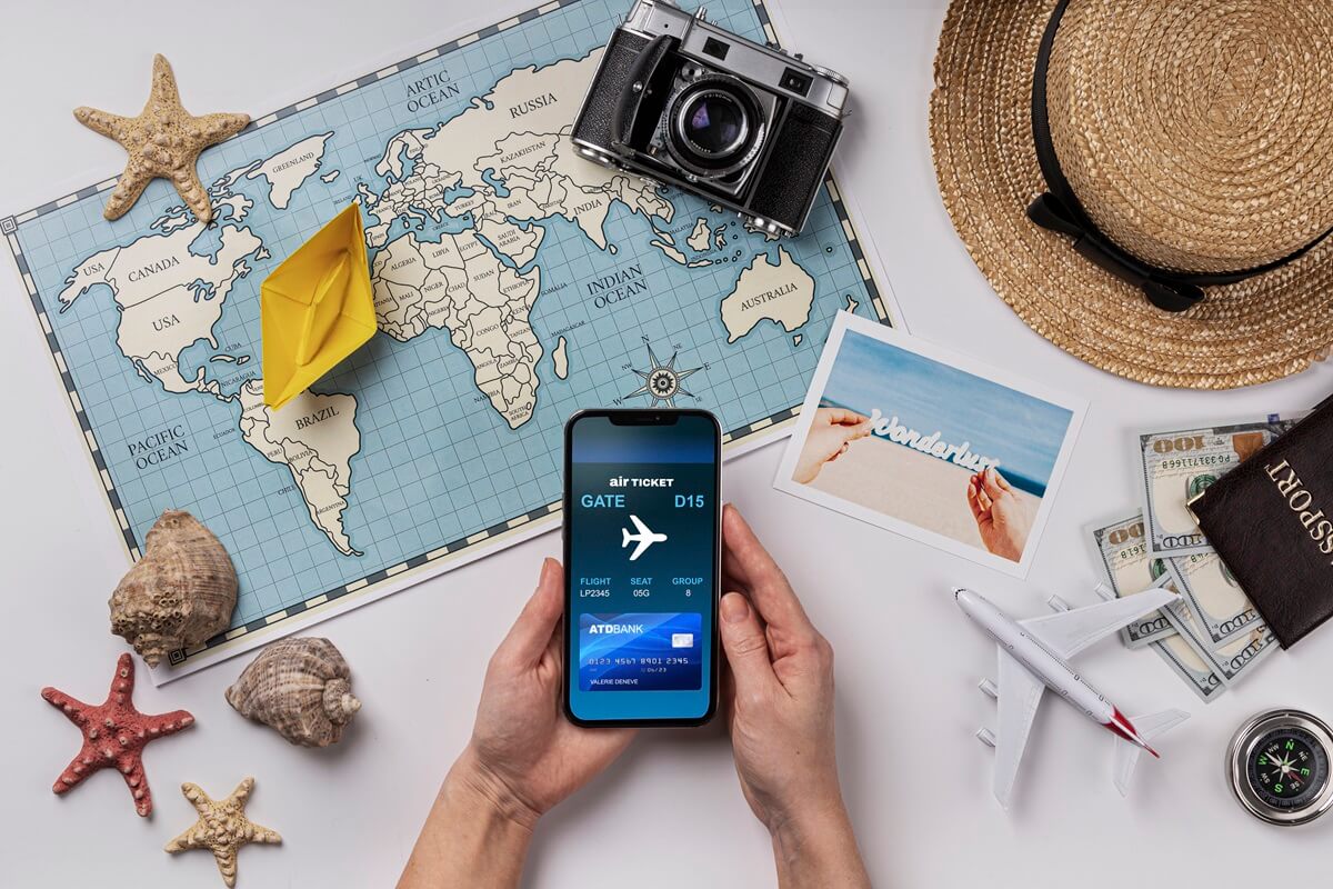 world-map-top-view-hands-holding-smartphone